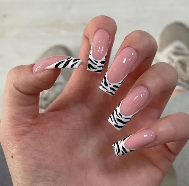 stunning and eye-catching zebra nails french nail art design with sophisticated color choices on perfectly shaped nails, showcasing classic French tip elegance
