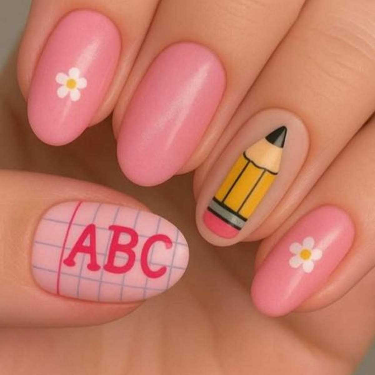 Elegant almond nails featuring yellow pencil tip French art with ultra-gloss finish for back to school.