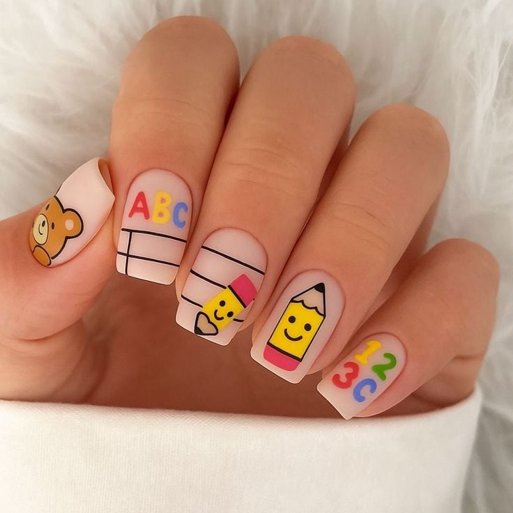 Short square nude nails with black fine-line school doodles and glossy top coat polish.