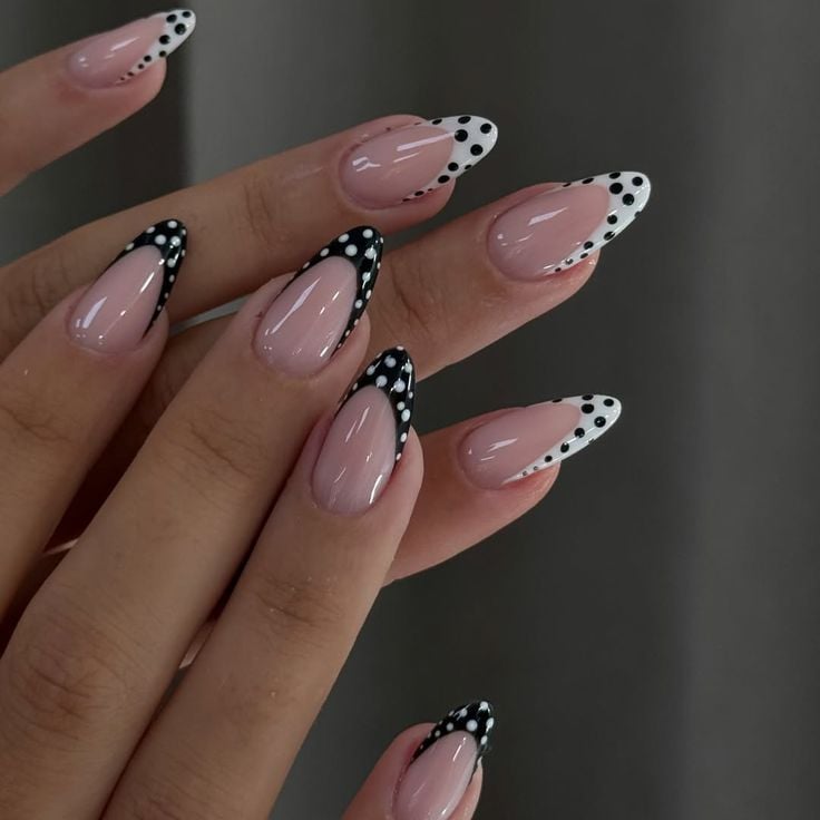 Black floral french tip nails on almond shape with glossy top coat for evening galas.