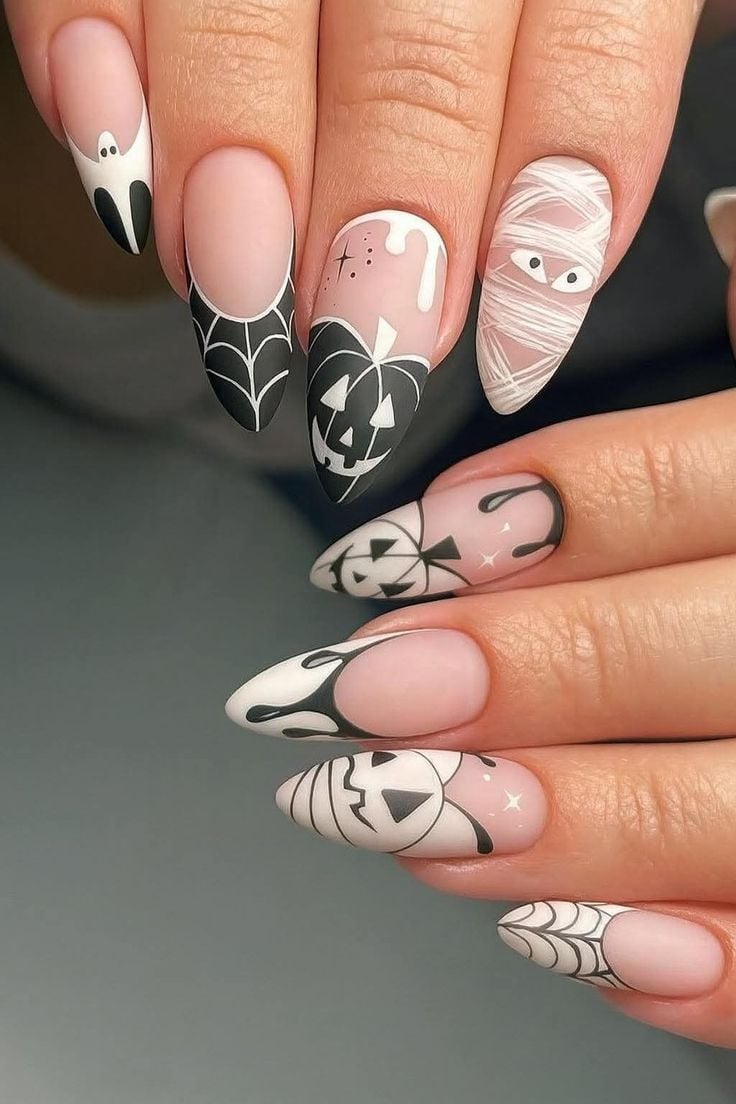 Round black and white glossy nails featuring spooky ghost and bat art for Halloween.