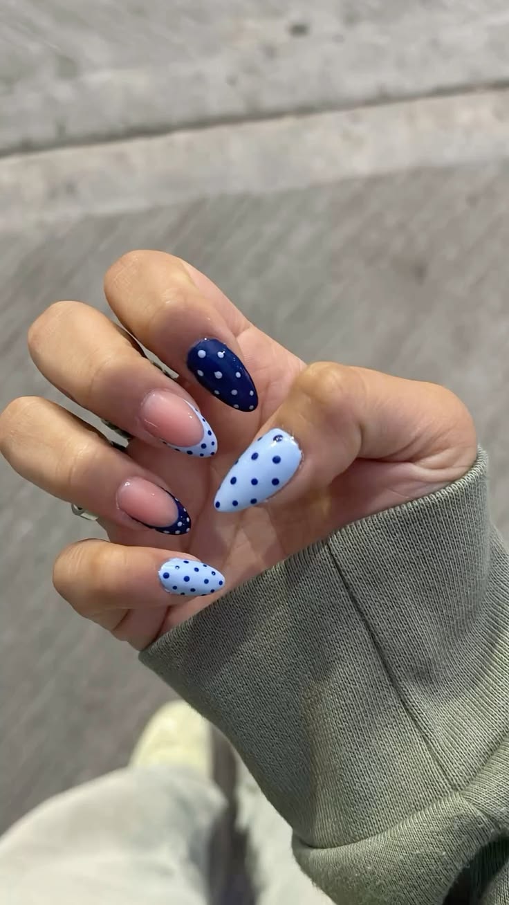 Vibrant cobalt blue dot french tips on short round glossy polish for summer vacation.