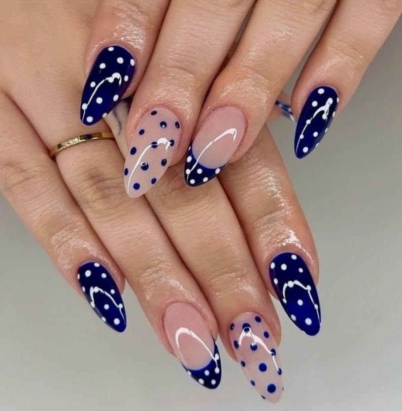 Ocean blue french tip nails with subtle white dots on coffin gloss for beach trips.