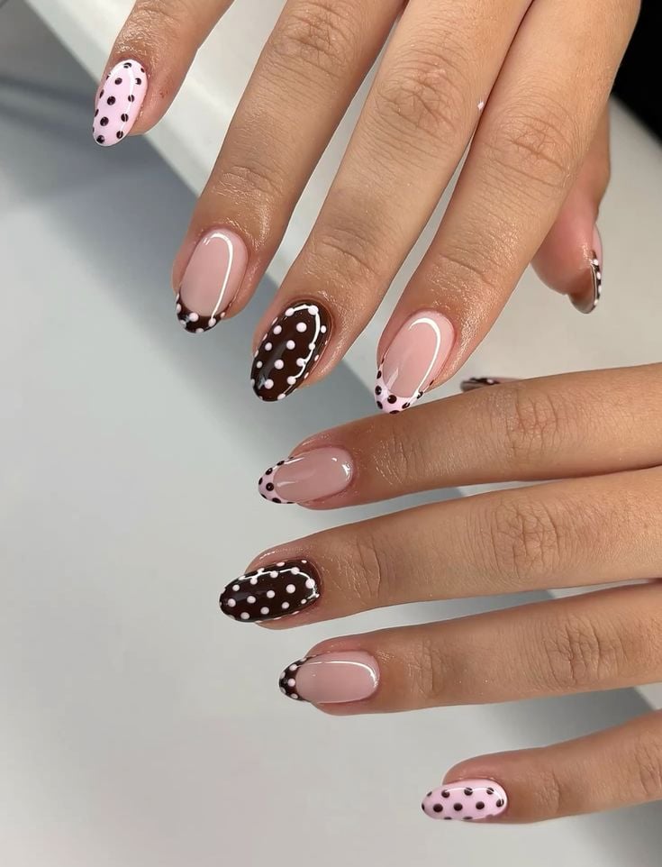 Warm taupe brown french tip nails with white dots on short oval shiny finish for office wear.