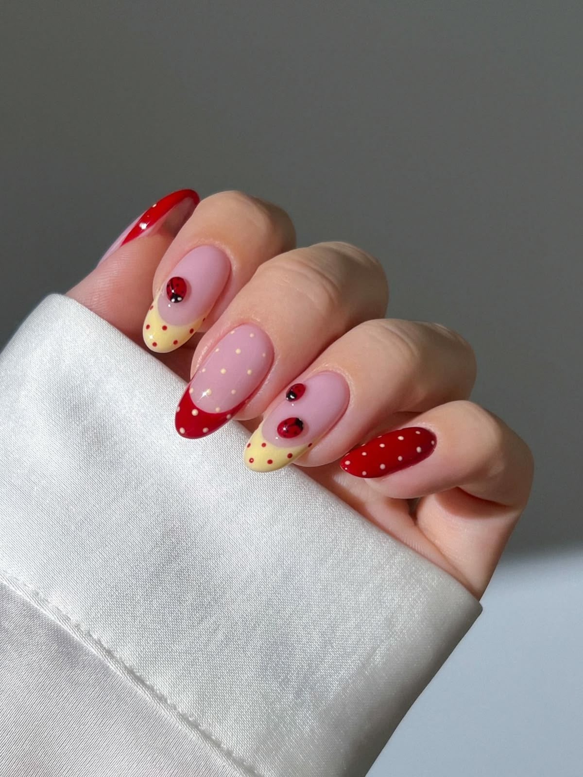 Cute cherry daisy french tip nails on almond glossy finish for summer picnics.
