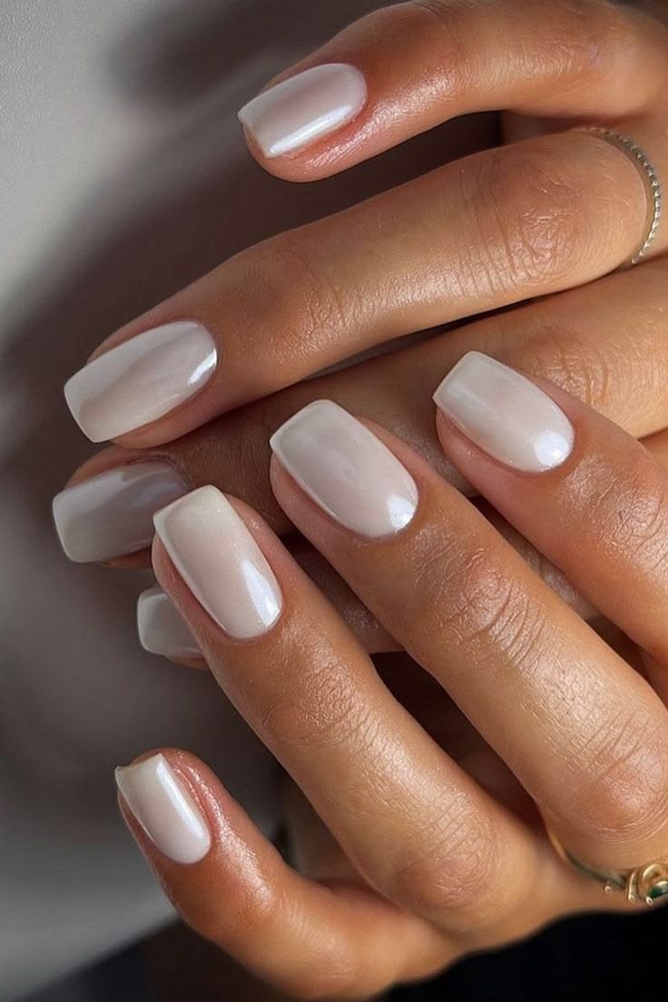 Almond shaped chrome milky white nails with a glazed finish for a cocktail party.