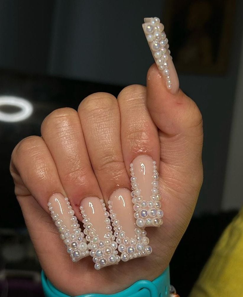 Medium coffin sheer pink french tip rhinestone nails with high gloss finish for weddings.