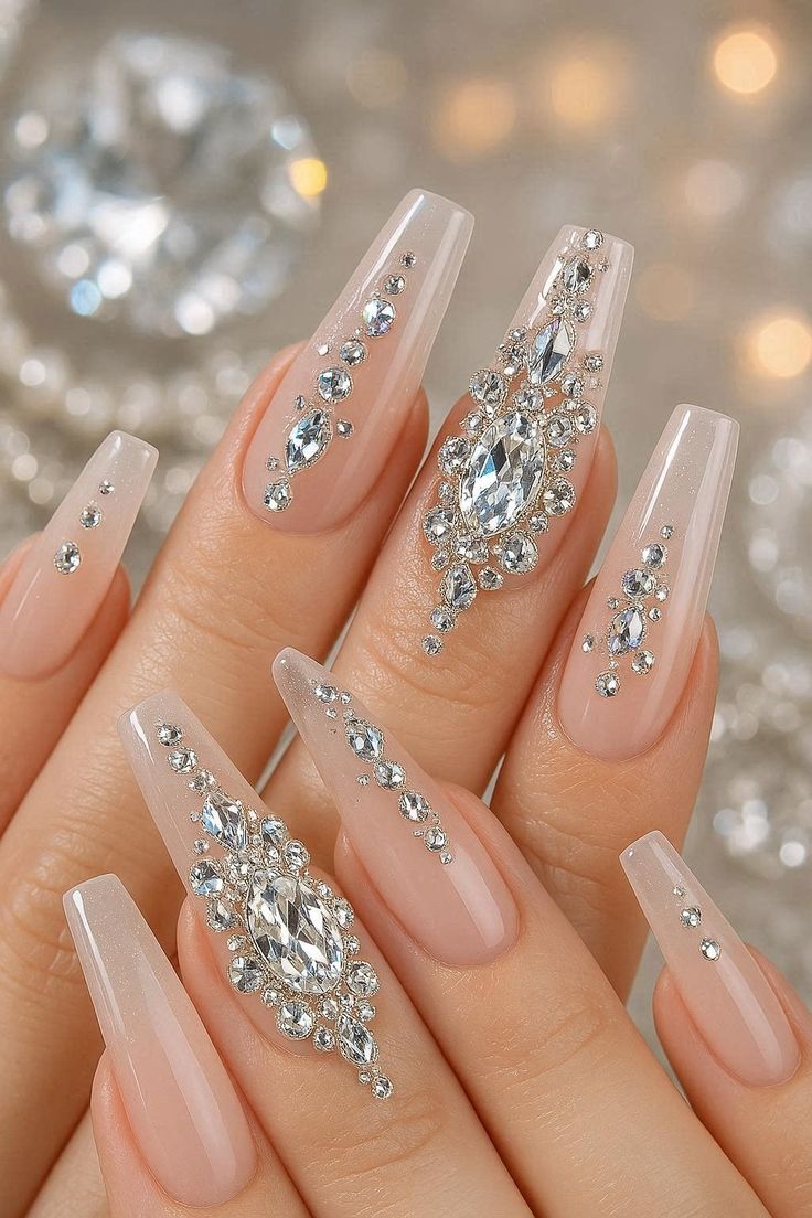 Long stiletto silver crystal rhinestone nails with high shine mirror finish for parties.