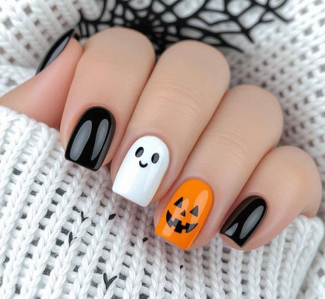 Oval pastel pink glossy nails with friendly white ghost illustrations for a cute Halloween.
