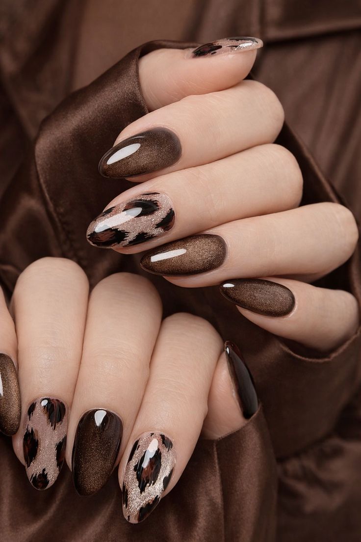 Elegant Brown Almond Nails With A Leopard Print Accent And Glossy Chocolate Finish