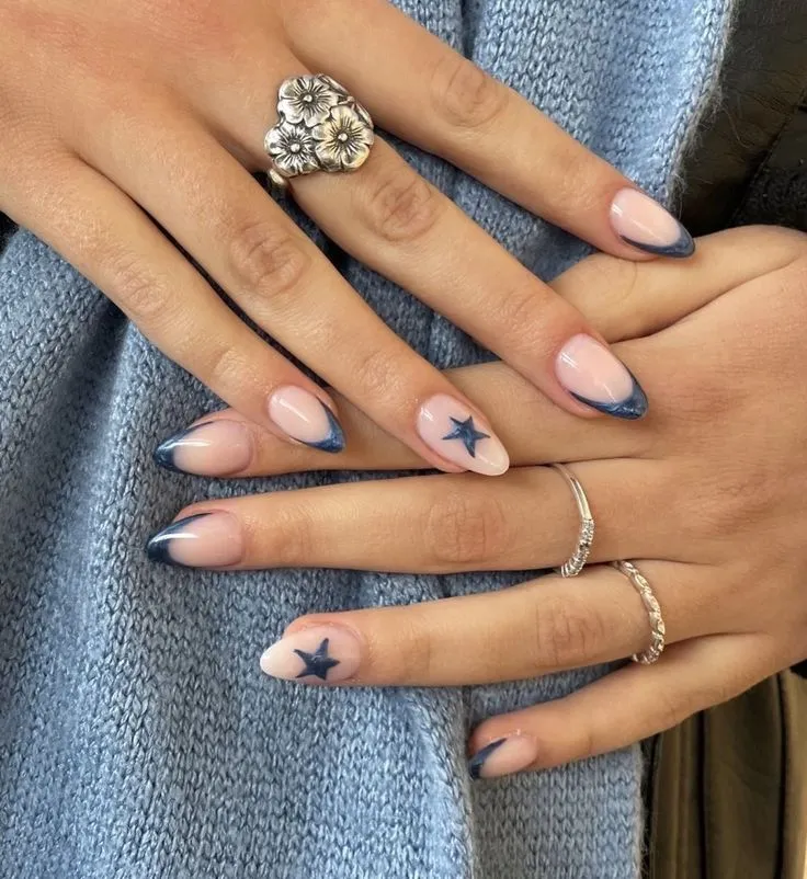 Modern French tip nails with matte nude base and black white tips with heart accents