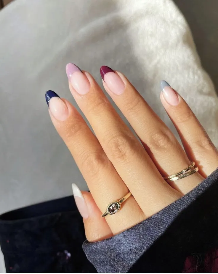 Sophisticated French tip nails with navy blue tips and gold diagonal accent lines with star embellishments