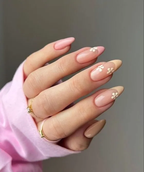Light blue French tip nails with dark blue floral designs and delicate flower patterns