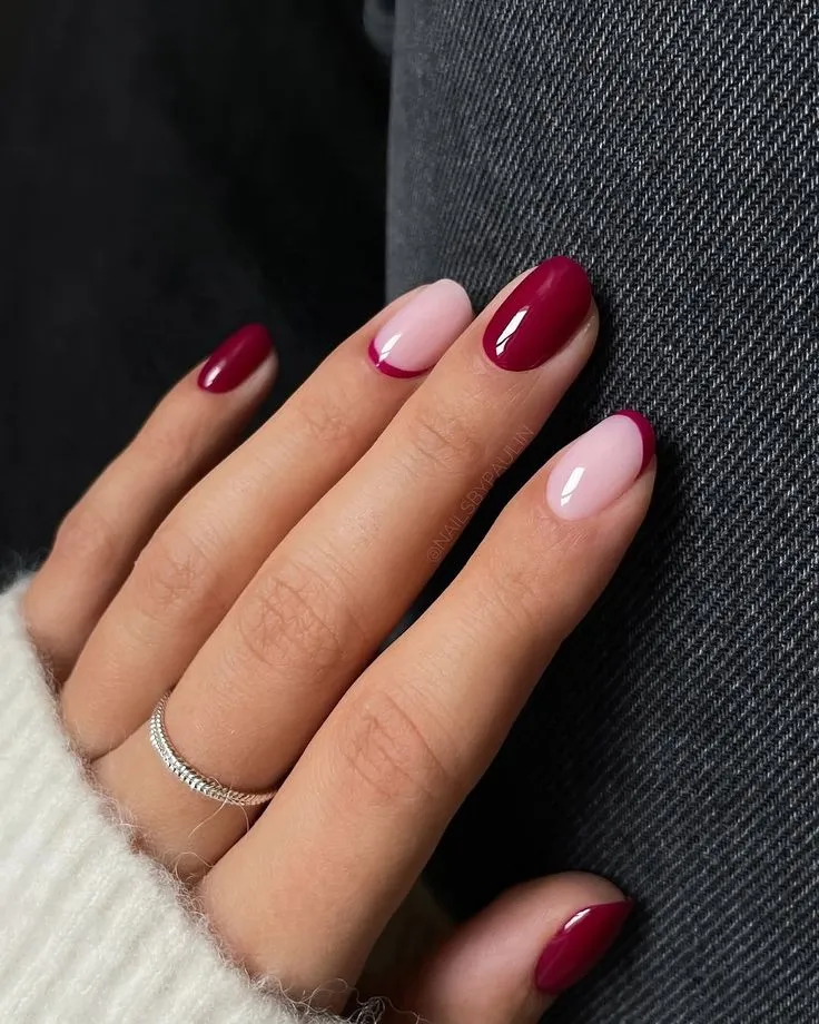 Modern French tip nails with sleek black tips and gold star ring embellishments