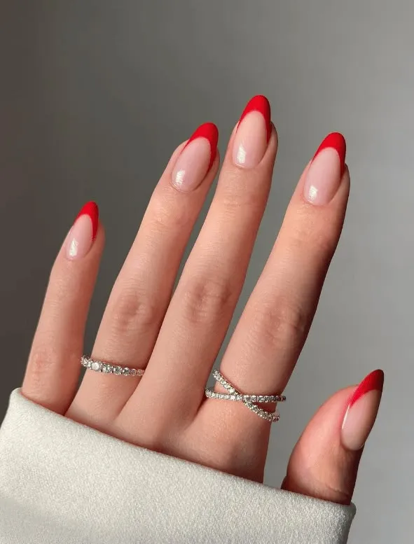 Wavy French tip nails with periwinkle blue tips and organic flowing curves for artistic flair