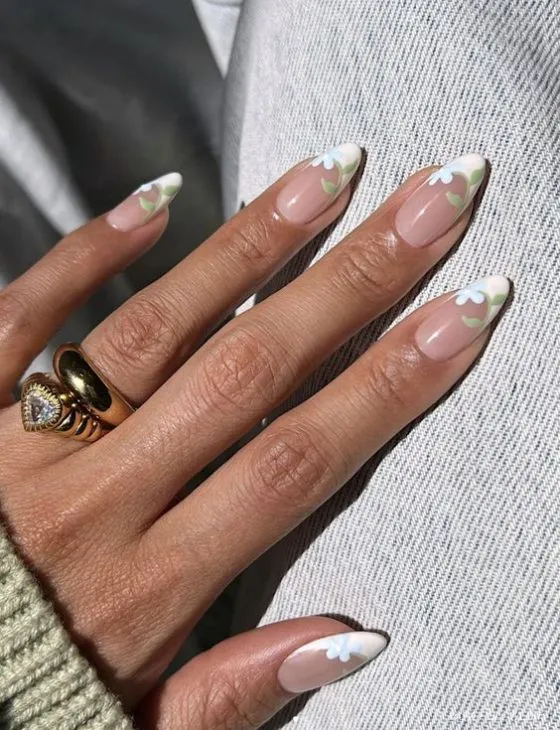 Elegant French tip nails with sheer pink base and fine iridescent glitter with bow ring