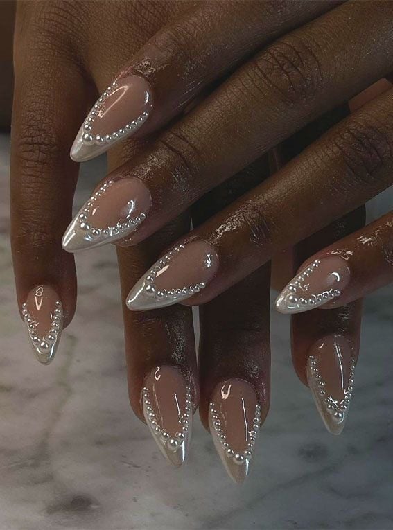 Almond shaped modern French tips over a milky white base for graduation ceremonies.