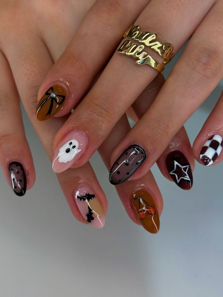 Short round glossy nude nails with minimalist white ghost designs for Halloween.