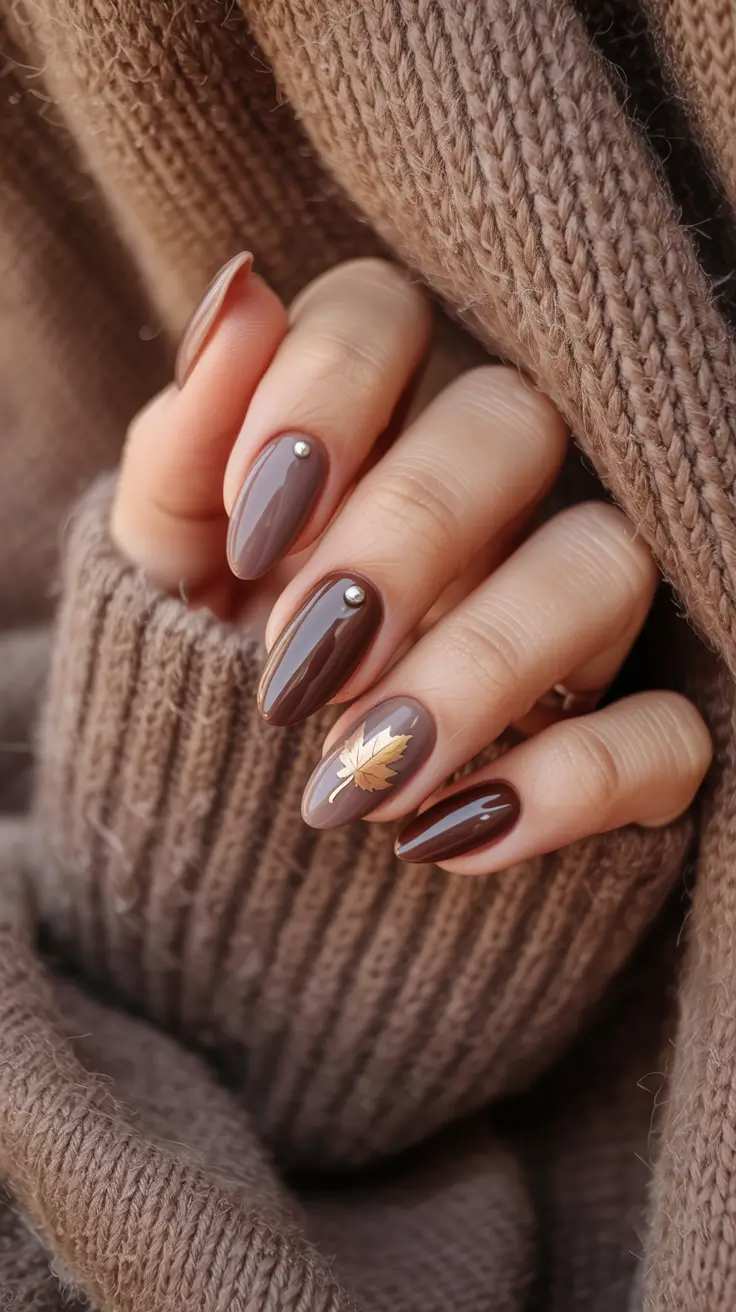 Glossy Chocolate Brown Oval Nails With Gold Maple Leaf
