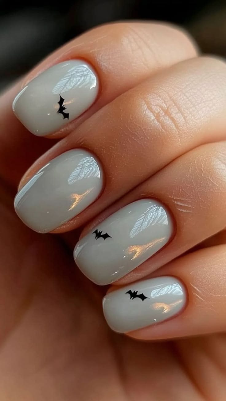 Glossy Grey Gel Nails With Mini Black Bat