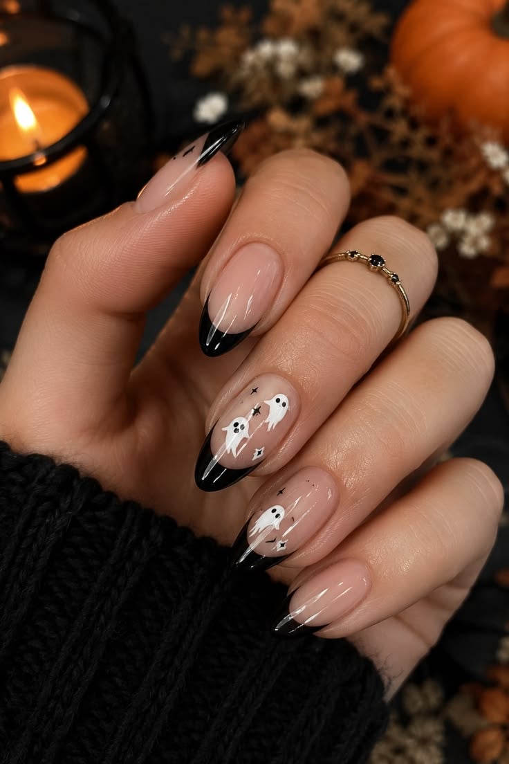 Long square glossy nude nails with haunted black French tips and bat art.