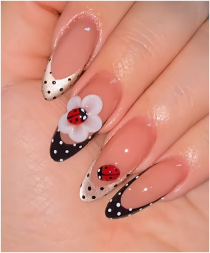 Red and black ladybug french tip nails on short round glossy polish for playful looks.