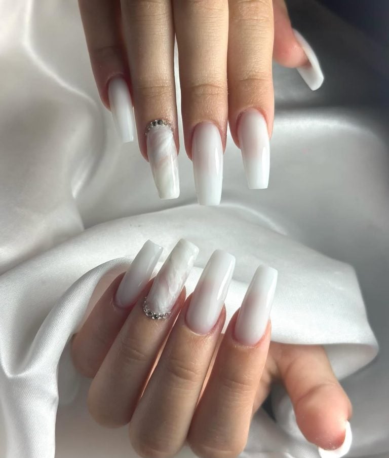 Long coffin shaped thick milky white gel overlay nails for a glamorous holiday.