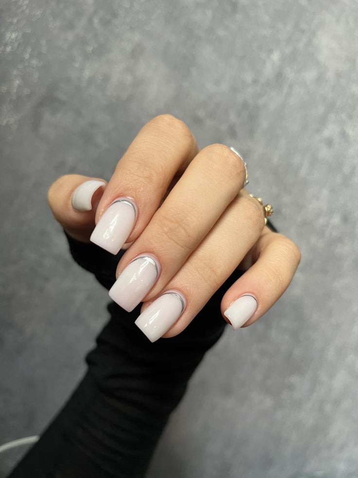 Almond shaped metallic white milky nails with a chrome glaze for music festivals.