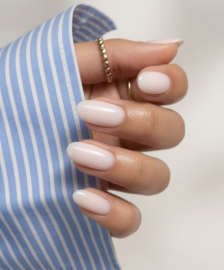 Almond shaped warm milky white gel nails for a relaxing weekend getaway.