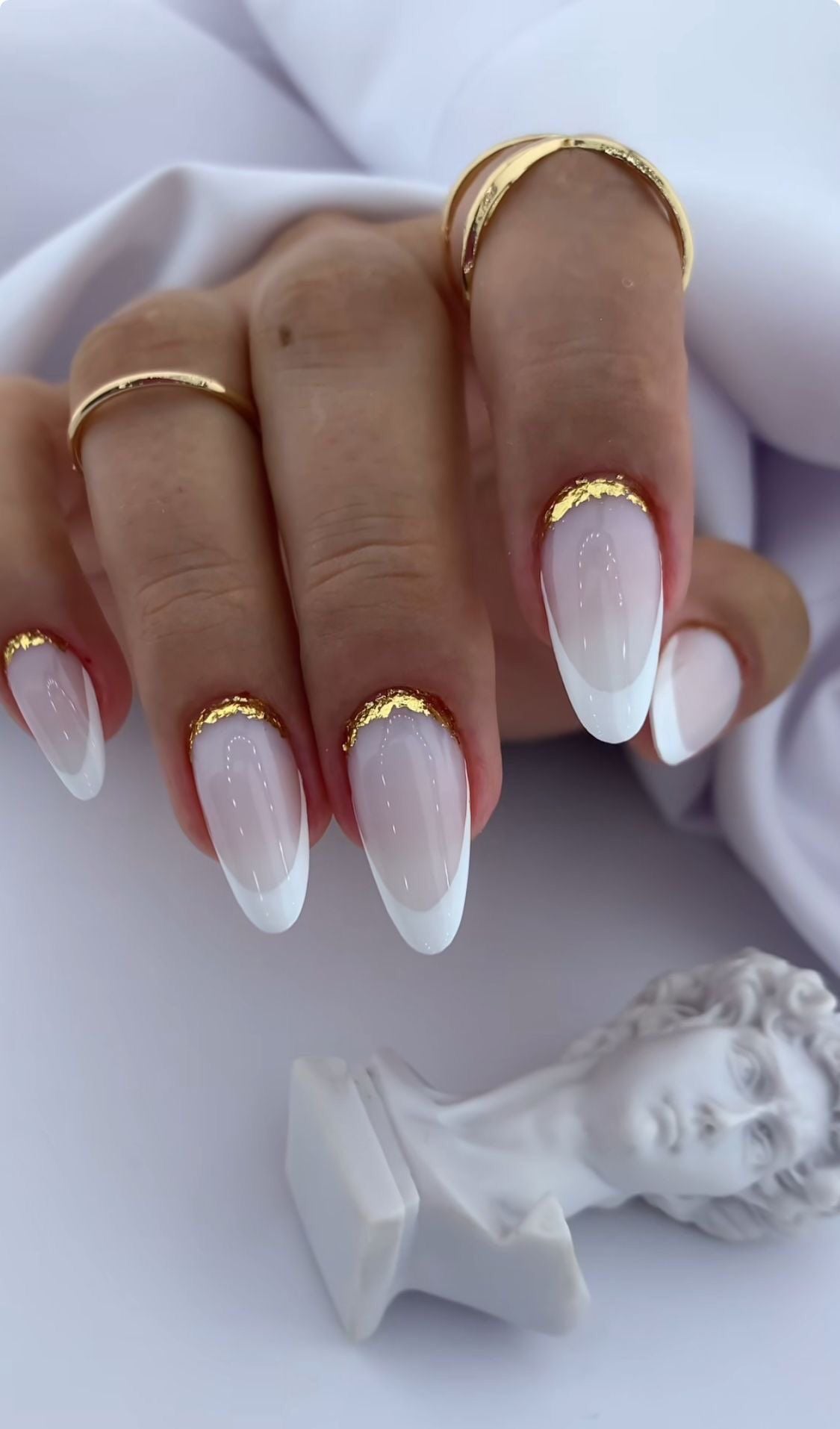 Coffin shaped modern milky white French tip nails for a corporate business meeting.