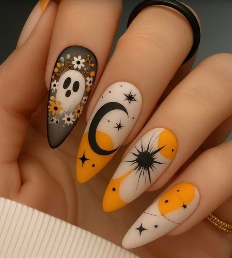 Almond shaped deep navy blue glossy nails with gold crescent moon and stars.