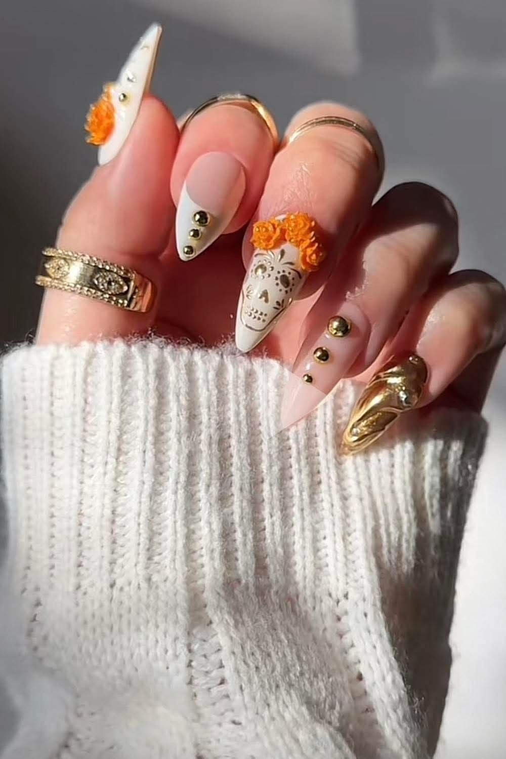 Squoval vibrant glossy orange and matte black geometric split nails for Halloween.