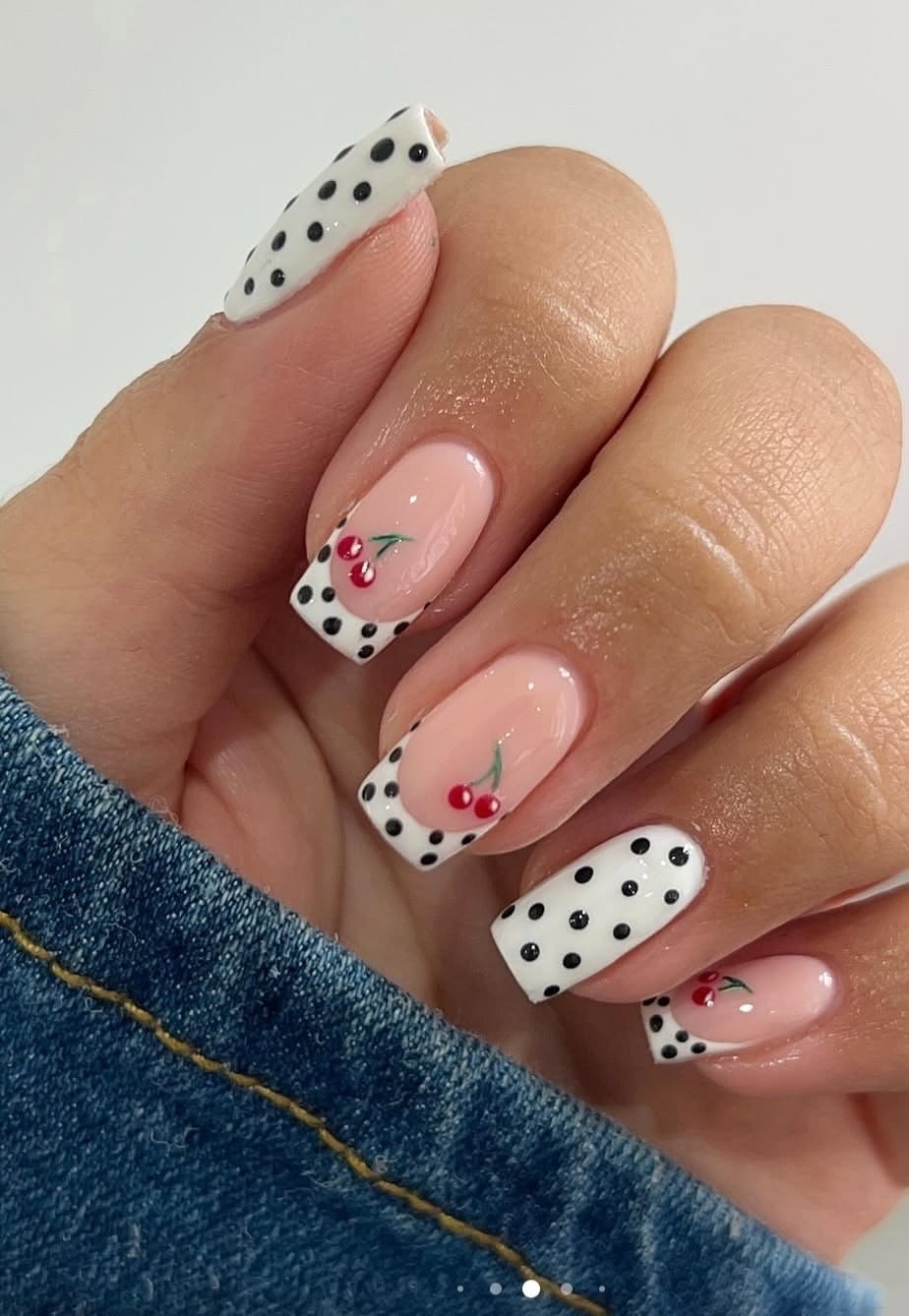 Soft peach dot french tip nails on almond shiny polish for warm summer days.