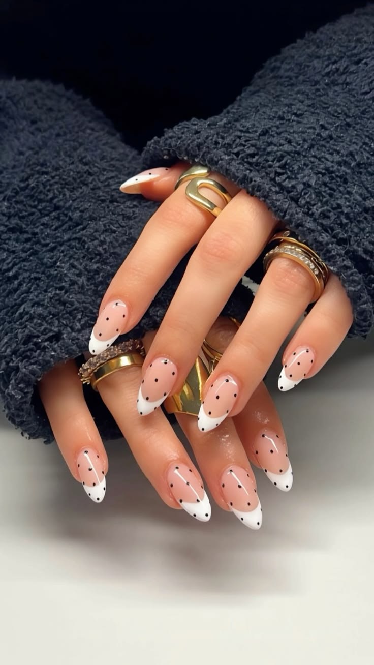 Apricot peach polka dot french tip nails on short square glossy acrylics for spring.