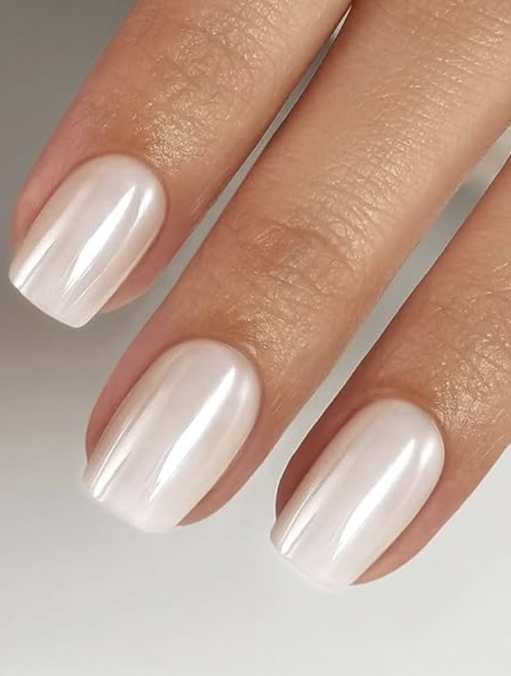 Almond shaped pearlescent milky white shimmer nails for a romantic beach wedding.