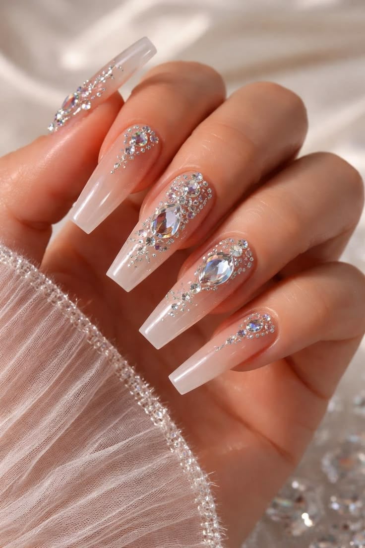 Long coffin pink glitter ombre rhinestone nails with ultra glossy finish for festival glam.