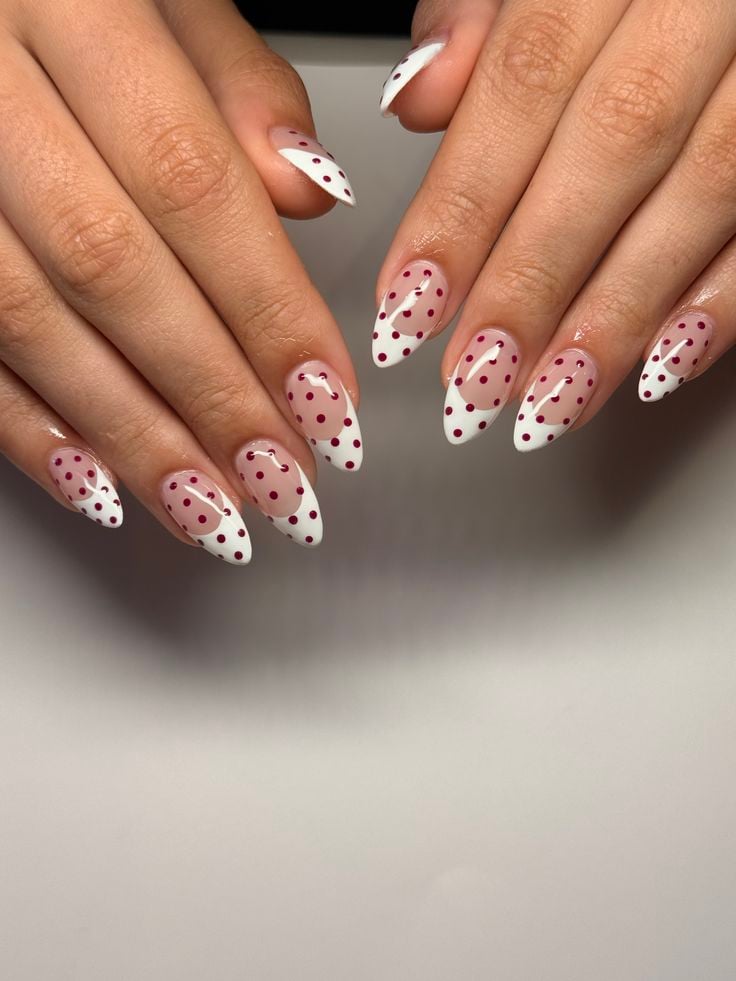 Soft baby pink polka dot french tip nails on coffin glossy gel for romantic occasions.