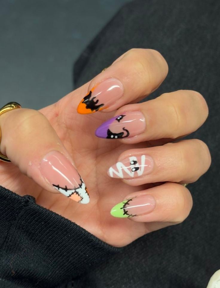 Short square glossy orange nails with cute jack-o-lantern face accents for Halloween.