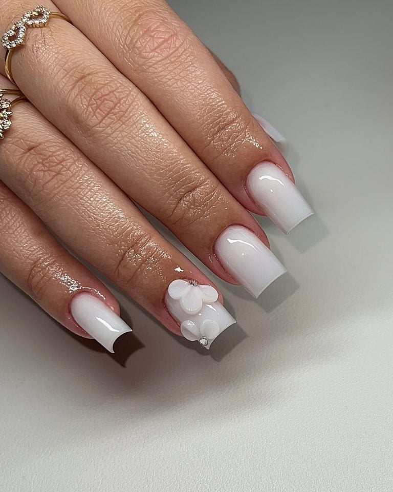 Long stiletto shaped sculpted milky white builder gel nails for high fashion events.