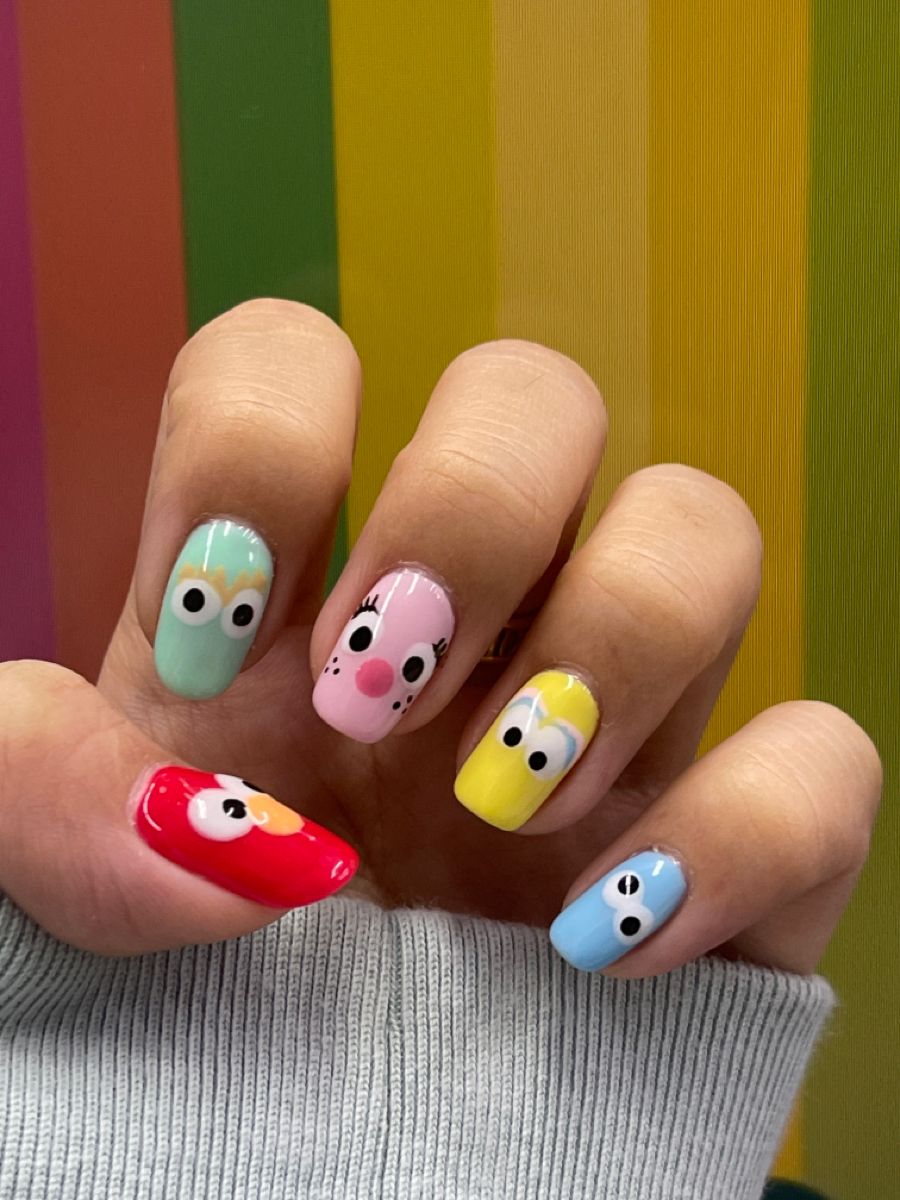 Colorful square nails with hand-painted Elmo and Cookie Monster faces for back to school.