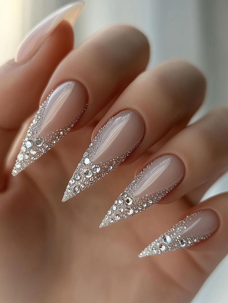 Medium almond silver glitter cascade rhinestone nails with glass shine finish for winter weddings.