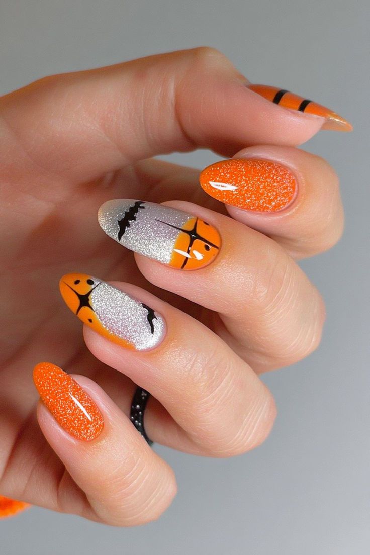 Coffin shaped glossy black nails with silver glitter ombre and web art.