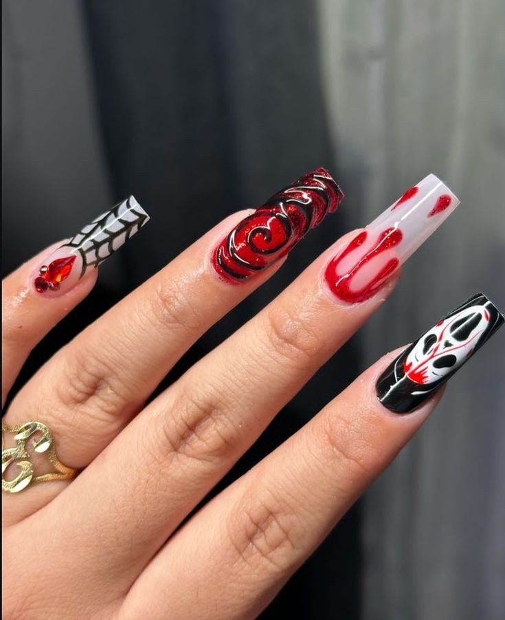 Medium square glossy orange, black, and white nails with abstract festive patterns.