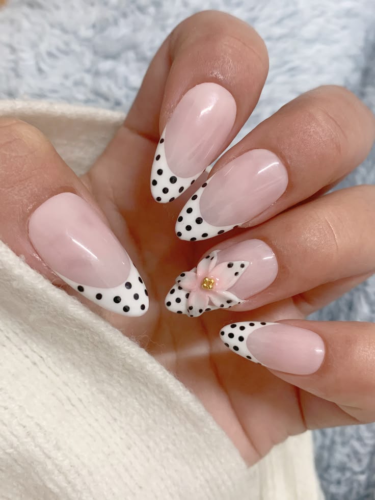 White flower french tip nails with dots on almond glossy gel for spring aesthetic.