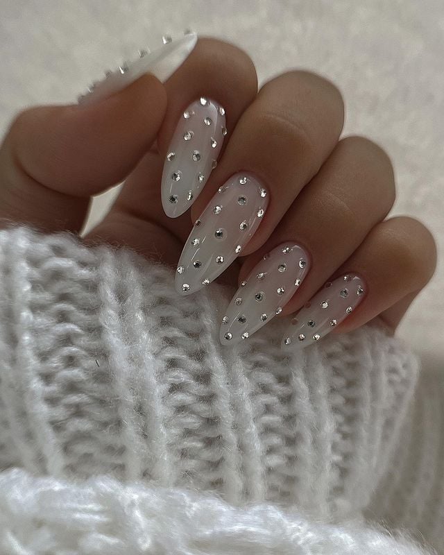Medium almond milky white pearl rhinestone nails with gloss finish for wedding ceremony.