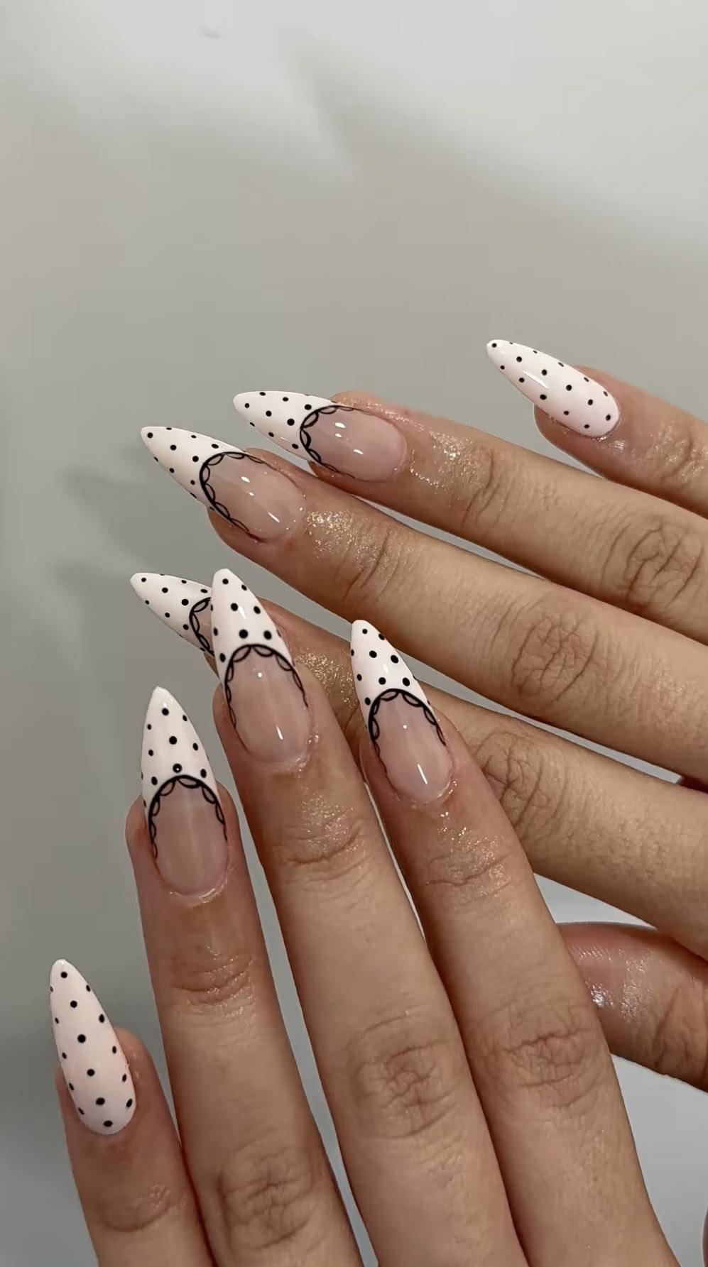 Classic white polka dot french tip nails on square shape glossy gel polish.