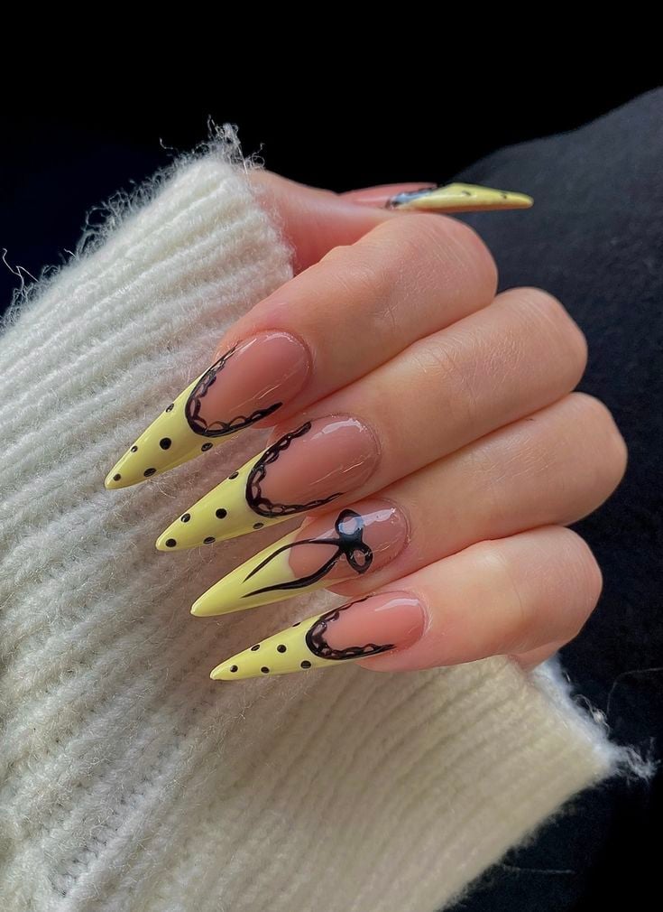 Sunny yellow dot french tip nails on short square glossy gel polish for summer.